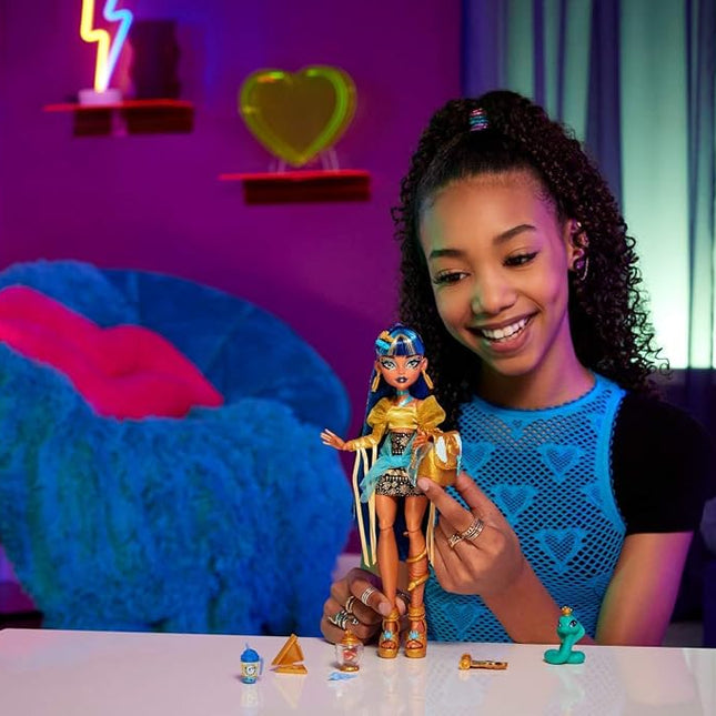 Monster High Cleo De Nile Doll in Golden Blouse and Layered Skirt, Includes Pet Cobra Hissette and Accessories Like a Backpack, Snack and Scroll