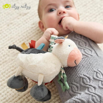 Itzy Ritzy Link & Love Toy for Stroller or Car Seat; Features Textured Ribbons, Crinkle Sounds, Clinking Rings & Silicone Teether; Designed For Ages 0 Months and Up (Cow)