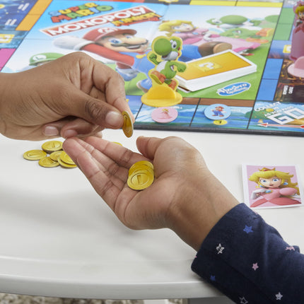 MONOPOLY Junior Super Mario Edition Board Game, Fun Kids' Game Ages 5 and Up, Explore The Mushroom Kingdom as Mario, Peach, Yoshi, or Luigi
