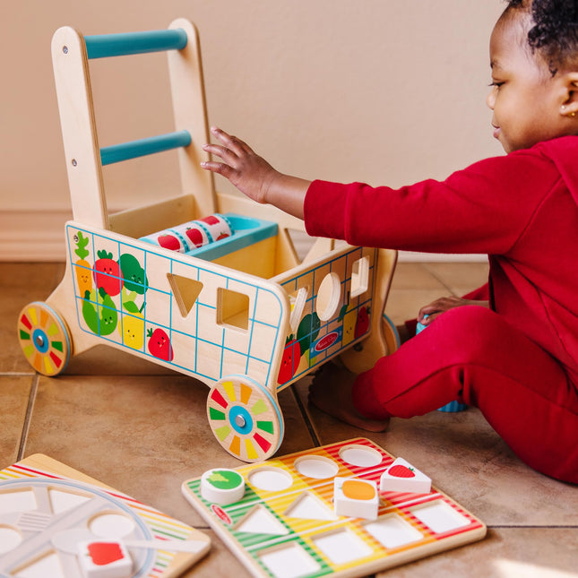 Melissa & Doug Carrito de Compras de Madera con Clasificador de Formas y Rompecabezas | Clasificador de Formas | Juguete de Madera para Niños | Juguete de Desarrollo para Niños Pequeños | 0+ | Regalo para Bebés o Niñas - Certificado FSC