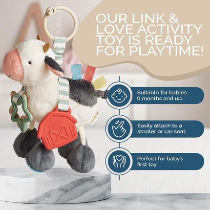 Itzy Ritzy Link & Love Toy for Stroller or Car Seat; Features Textured Ribbons, Crinkle Sounds, Clinking Rings & Silicone Teether; Designed For Ages 0 Months and Up (Cow)
