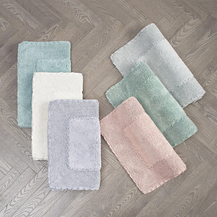 Juego de 2 alfombras de baño de algodón con volantes Laura Ashley, blancas