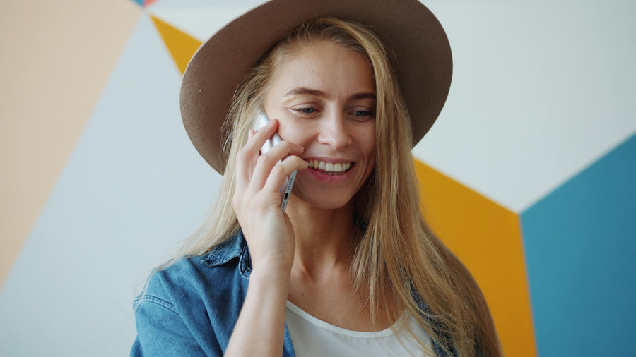 Friendly customer support agent smiling while on a phone call, helping a customer